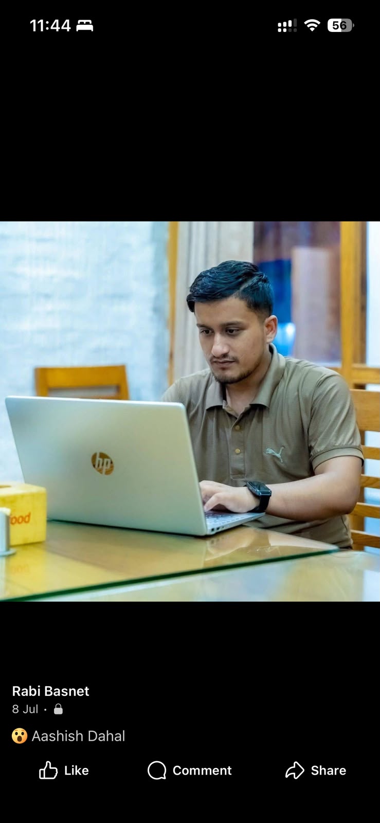 Rabi Basnet working on a laptop